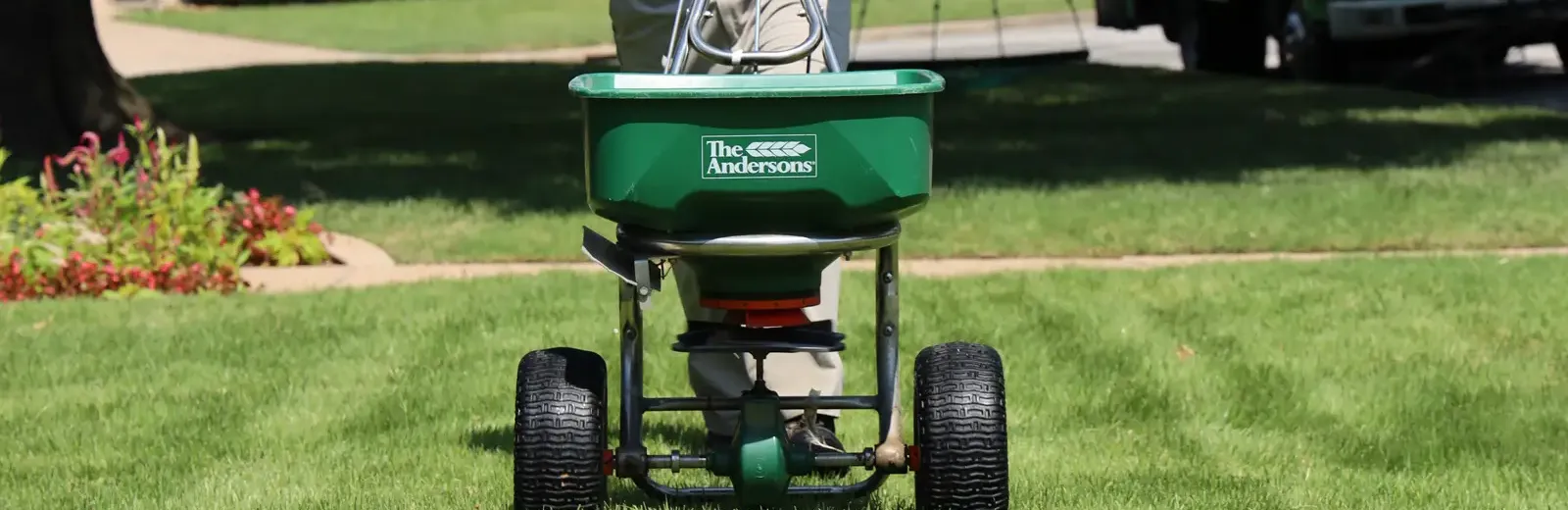 nutri-green service technician fertilizing on lawn